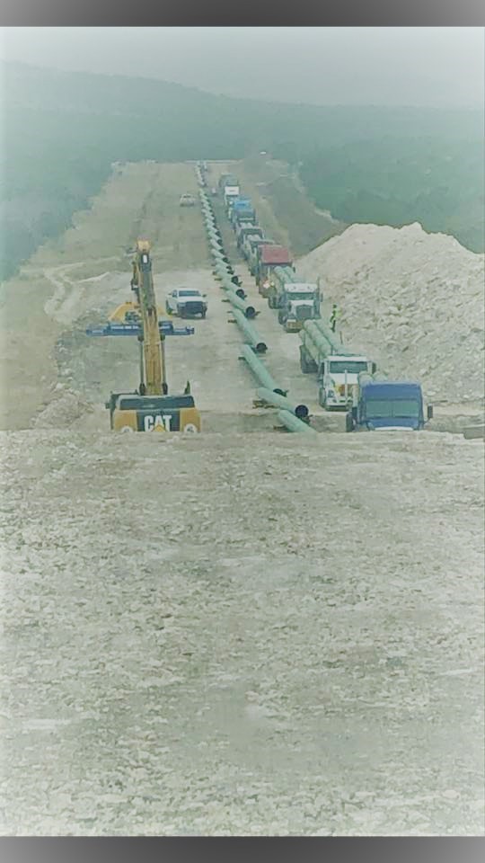 Active pipeline construction project with crews and equipment